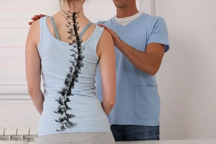 A man standing next to a woman with a spinal cord injury.