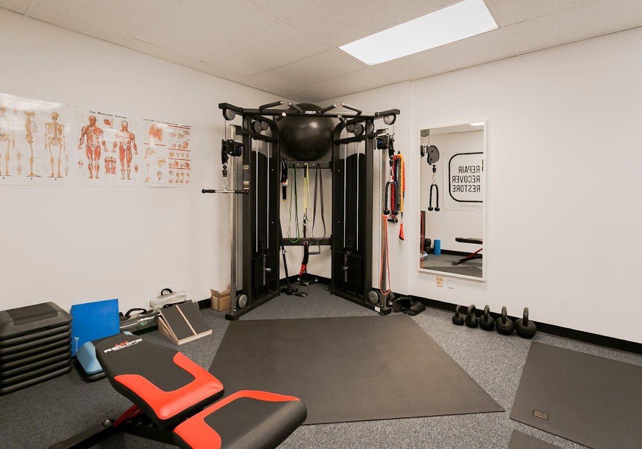 A gym with many different equipment in it